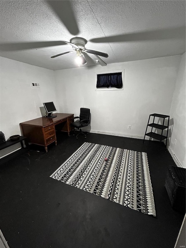 office area featuring baseboards, a ceiling fan, and a textured ceiling