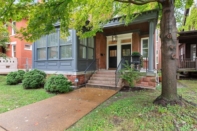 view of front of house featuring a porch and brick siding