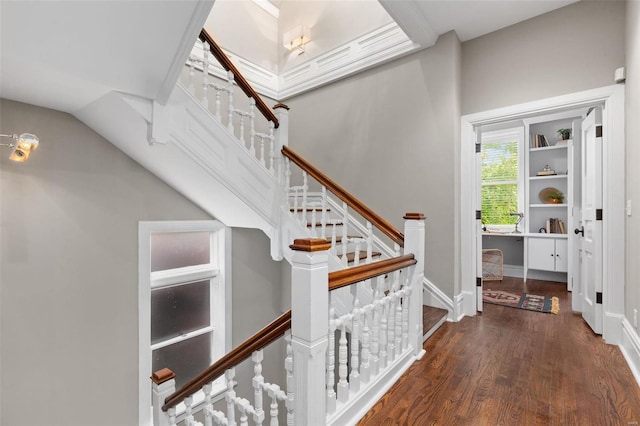 interior space with stairs, wood finished floors, and baseboards