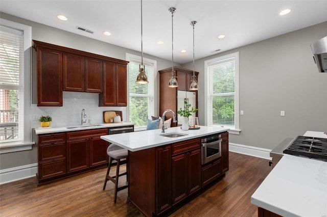 kitchen featuring plenty of natural light, light countertops, and a sink