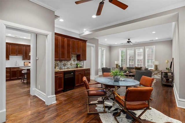 dining room with ornamental molding, visible vents, dark wood finished floors, and baseboards