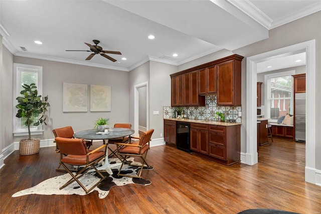 interior space featuring dark wood-style floors, backsplash, baseboards, and stainless steel refrigerator