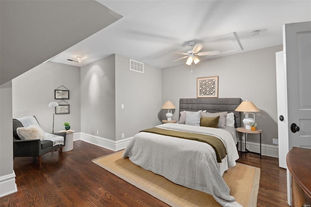 bedroom featuring a ceiling fan, visible vents, baseboards, and wood finished floors