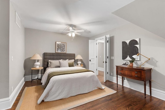 bedroom featuring a ceiling fan, wood finished floors, visible vents, and baseboards