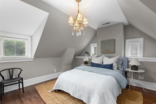 bedroom featuring visible vents, baseboards, and wood finished floors