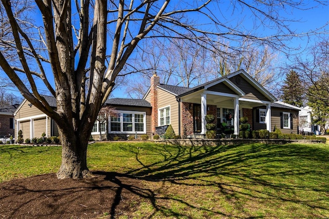 view of front of house with brick siding, a garage, a front lawn, and a chimney