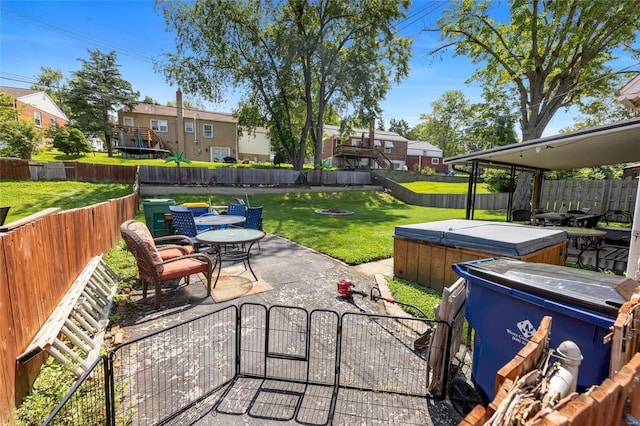 view of patio / terrace with a fenced backyard and a hot tub