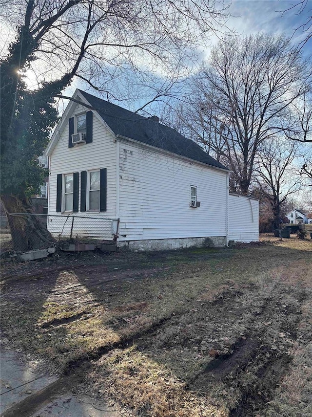 view of side of home featuring cooling unit