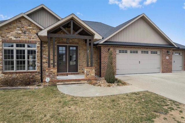 craftsman house with a garage, brick siding, concrete driveway, stone siding, and a front lawn