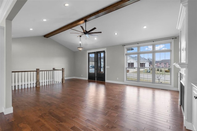 unfurnished living room featuring lofted ceiling with beams, a fireplace, baseboards, and wood finished floors