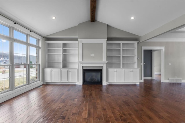 unfurnished living room with baseboards, visible vents, dark wood finished floors, a glass covered fireplace, and vaulted ceiling with beams