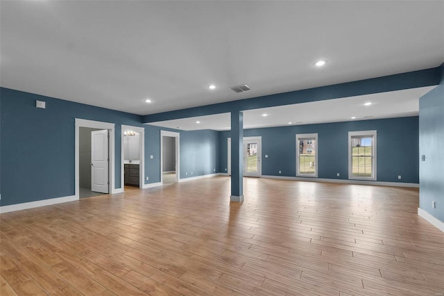 unfurnished living room with recessed lighting, baseboards, visible vents, and light wood finished floors