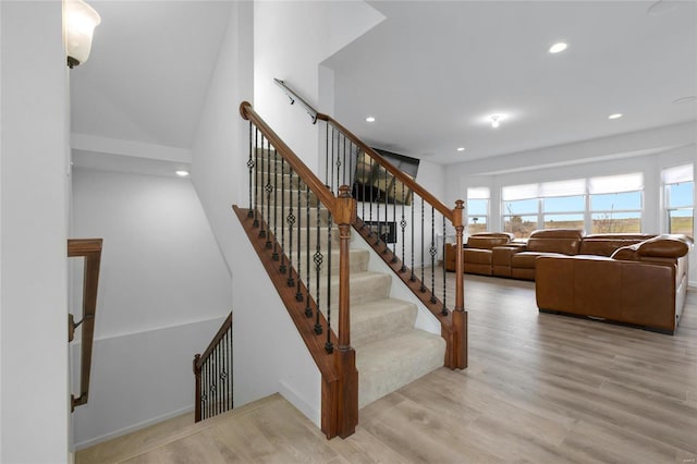 stairs featuring recessed lighting, wood finished floors, and baseboards