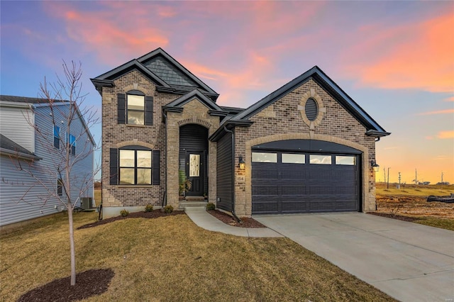 view of front of home with brick siding, a front lawn, concrete driveway, central AC, and a garage