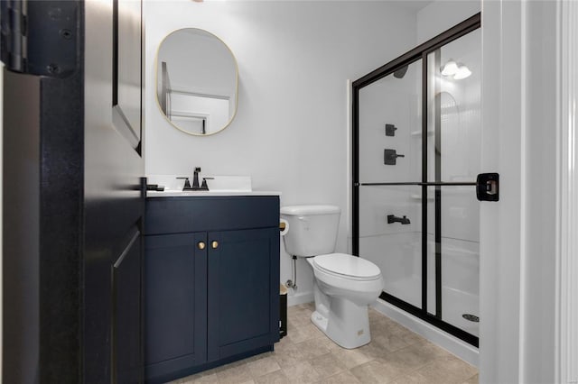 bathroom with a stall shower, toilet, and vanity