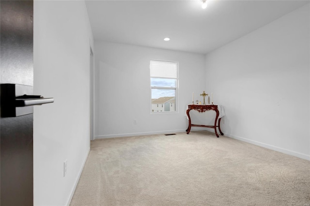 empty room with recessed lighting, baseboards, carpet floors, and visible vents