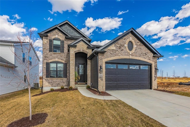 view of front of home featuring driveway, a front yard, a garage, brick siding, and central AC unit