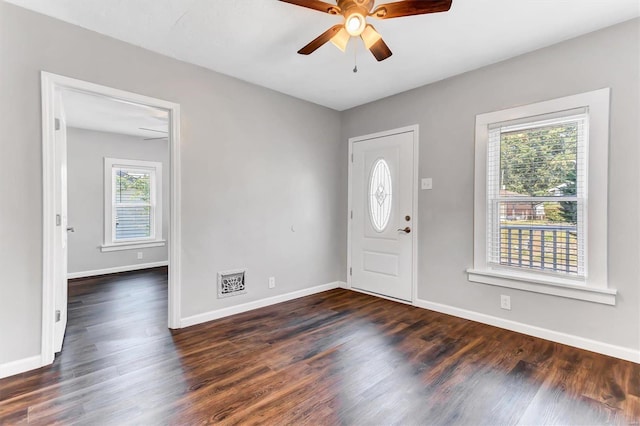 entrance foyer with visible vents, wood finished floors, a ceiling fan, and baseboards