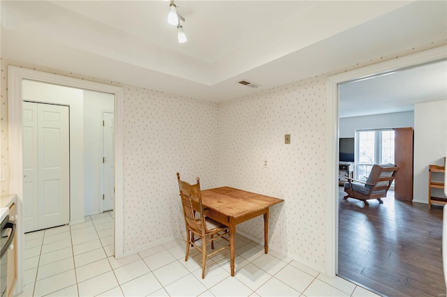 dining room with wallpapered walls, baseboards, light tile patterned floors, and visible vents