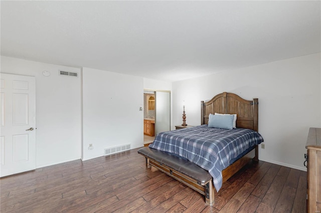 bedroom featuring hardwood / wood-style flooring, ensuite bath, and visible vents