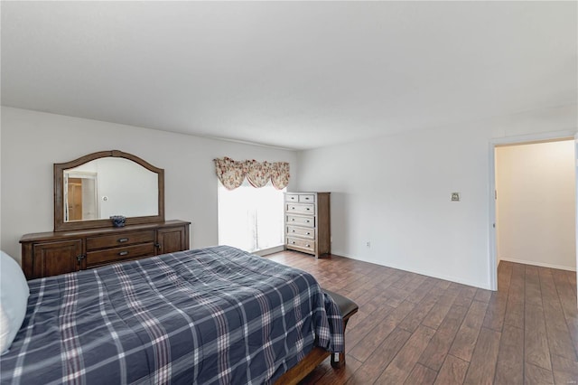 bedroom with wood finished floors and baseboards