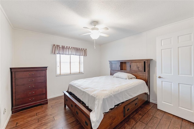 bedroom with a textured ceiling, a ceiling fan, and hardwood / wood-style floors