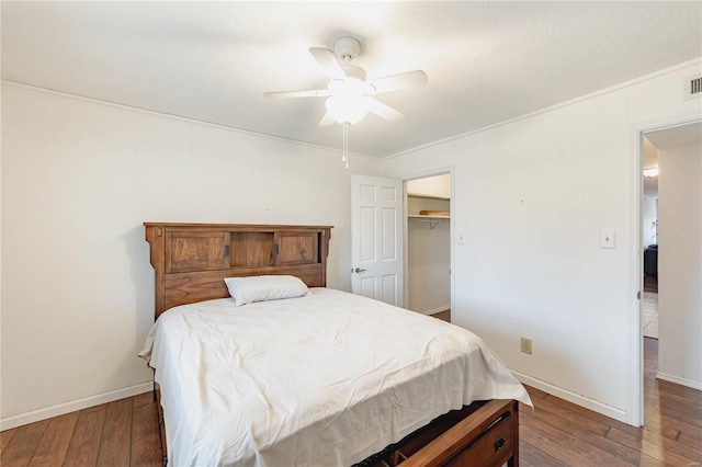 bedroom with hardwood / wood-style floors, a ceiling fan, visible vents, and baseboards