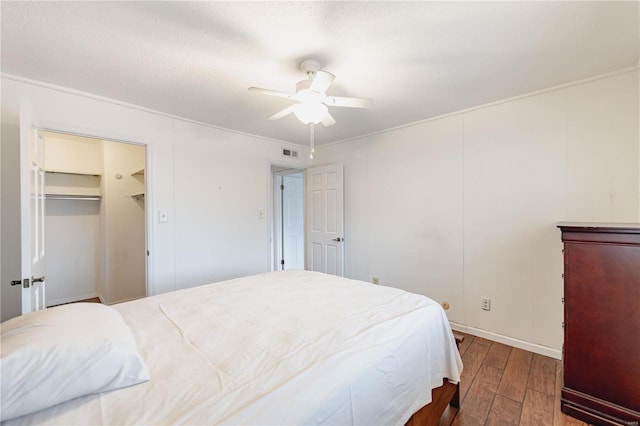 bedroom featuring wood-type flooring, visible vents, and ceiling fan