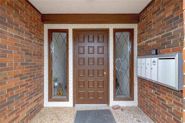 property entrance with brick siding