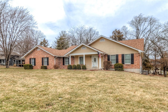 view of front of house with a front lawn and brick siding