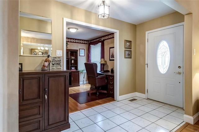 entryway with light tile patterned floors and baseboards