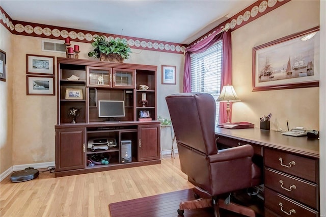 home office featuring visible vents, light wood-type flooring, and baseboards