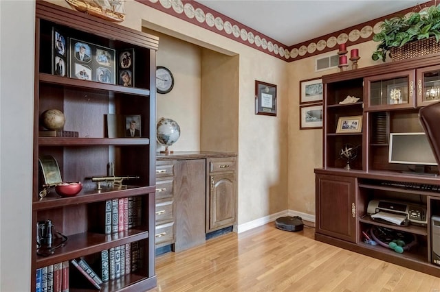 office space with visible vents, baseboards, and wood finished floors