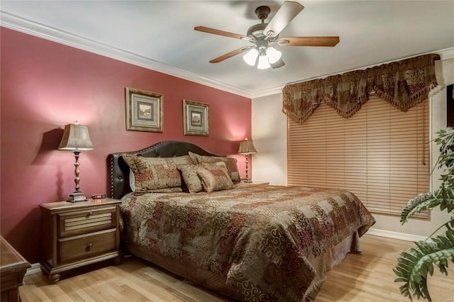 bedroom featuring baseboards, crown molding, a ceiling fan, and wood finished floors