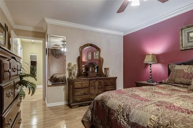 bedroom featuring a ceiling fan, wood finished floors, baseboards, and ornamental molding