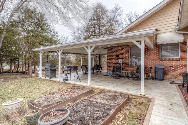 view of patio / terrace featuring grilling area and a garden