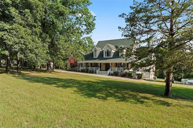 cape cod house featuring covered porch and a front lawn