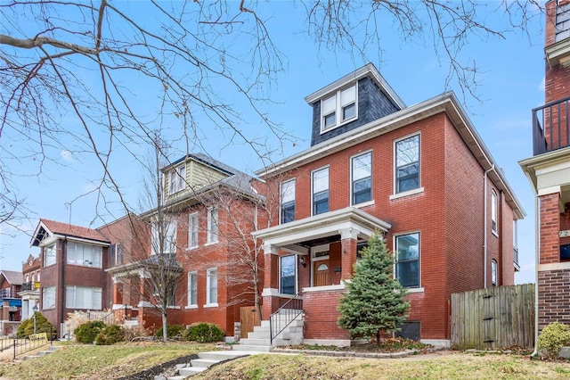 traditional style home with brick siding and fence