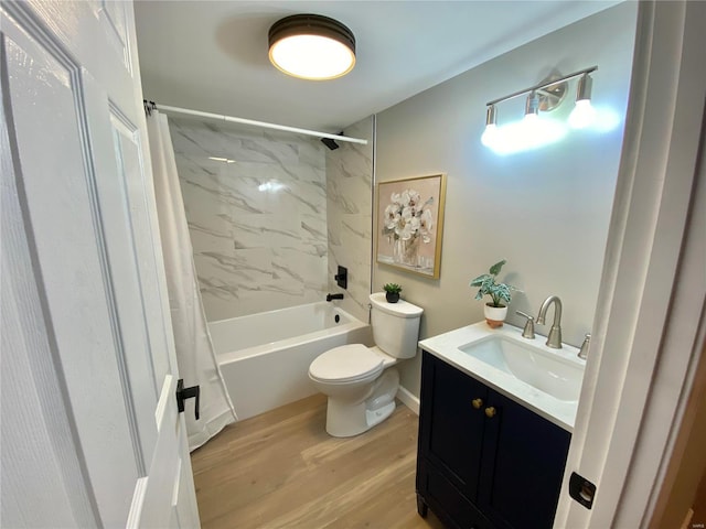 bathroom featuring toilet, shower / bath combo, wood finished floors, and vanity