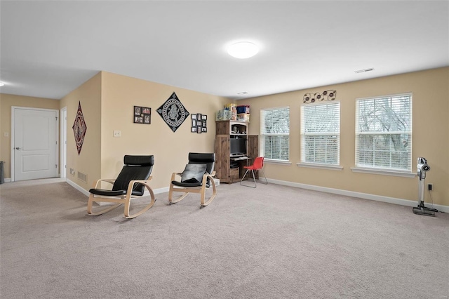 living area featuring carpet floors, visible vents, and baseboards