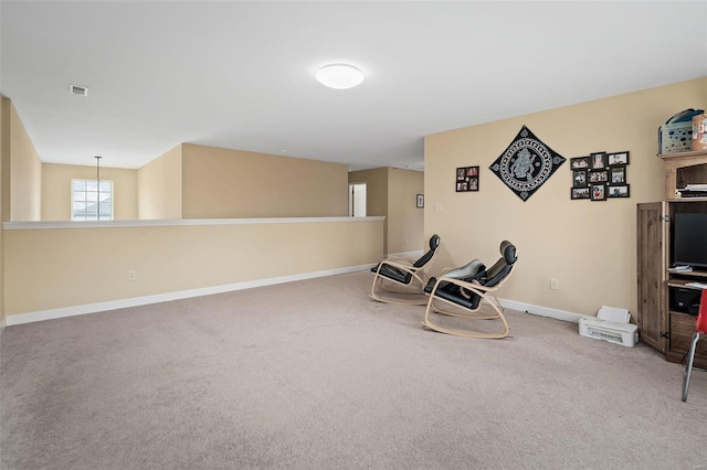 living area featuring baseboards, visible vents, and carpet flooring