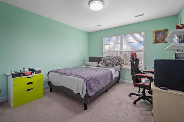 carpeted bedroom featuring visible vents and baseboards