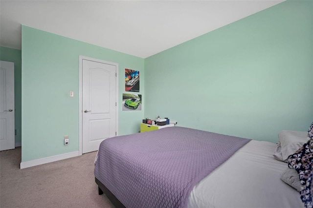 bedroom with carpet floors and baseboards