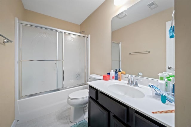 bathroom featuring shower / bath combination with glass door, visible vents, toilet, vanity, and tile patterned flooring