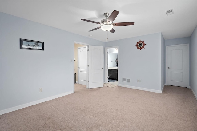 unfurnished bedroom with baseboards, visible vents, connected bathroom, and light colored carpet