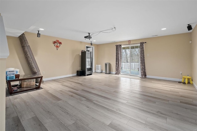 living room featuring light wood-style flooring, baseboards, and recessed lighting