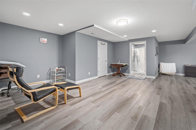 sitting room with light wood finished floors, recessed lighting, and baseboards