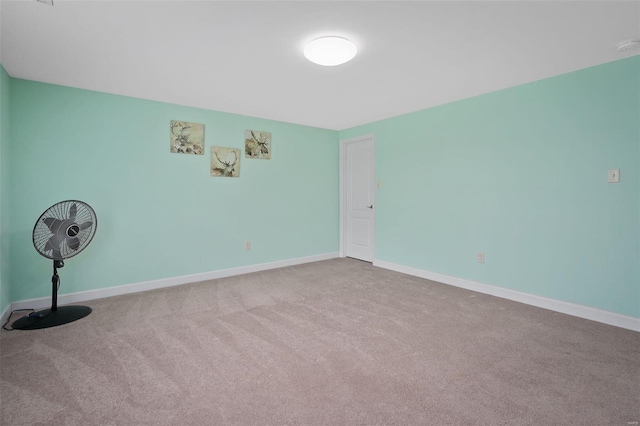 empty room with carpet floors and baseboards