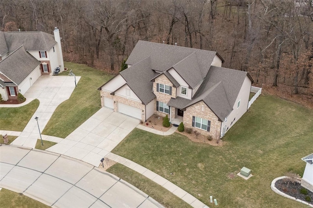 bird's eye view with a wooded view