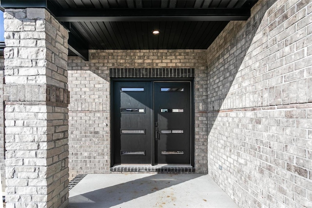 property entrance with brick siding